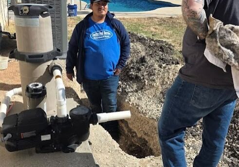 CenTex Pool Service technicians inspecting pool equipment during a repair and maintenance visit.