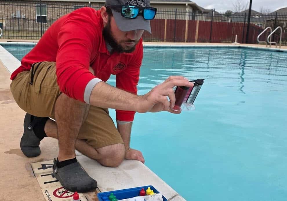 Pool technician testing water chemistry during pool service in Temple Texas